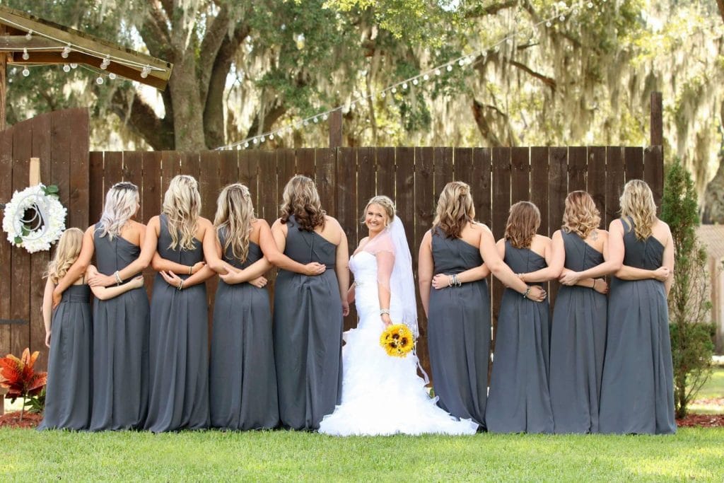 Harmony-Haven-Events-Bridesmaids with back to camera and Bride facing camera with sunflower bouquet