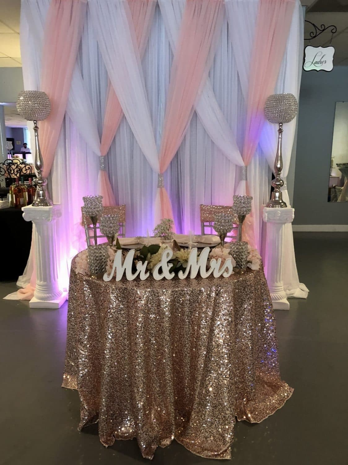 Amore Events Venue - sweetheart table backed with pink and white drapes