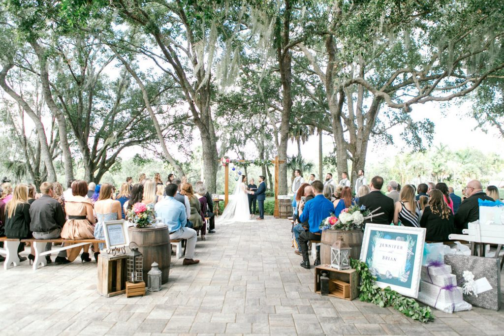 gorgeous outdoor ceremony under large oak trees by Bumby Photography