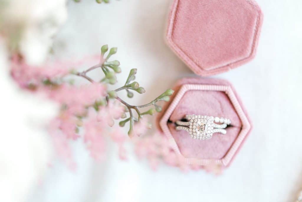 closeup of engagement ring in box by Bumby Photography