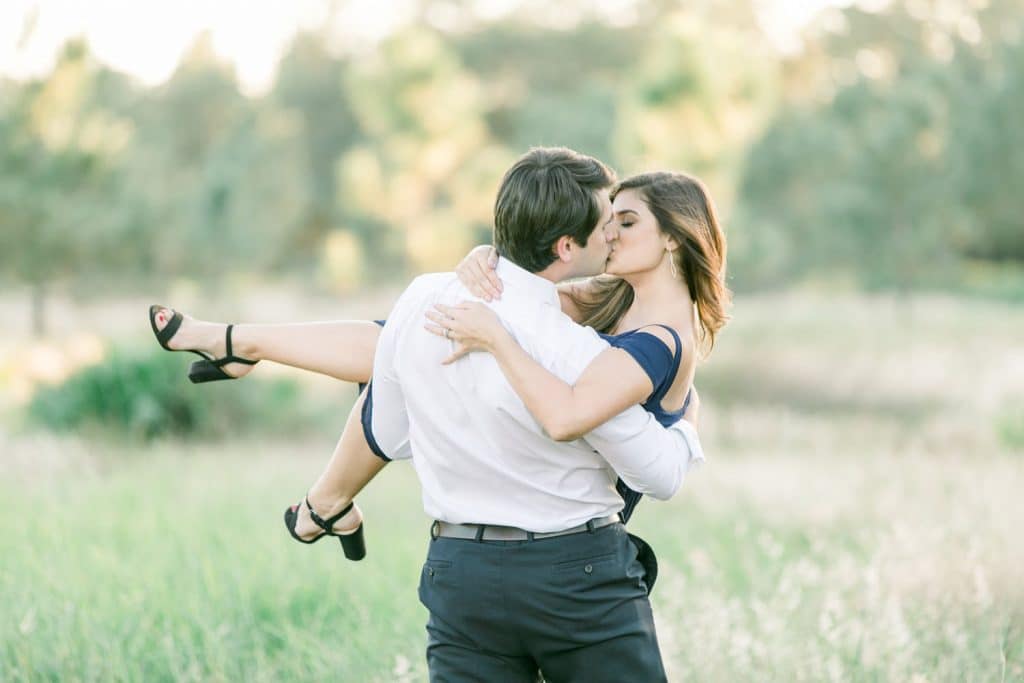 engagement photo man carrying woman by Bumby Photography