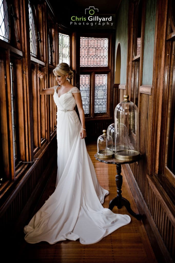 Chris Gillyard Photography - bride looking out of windows at historic venue