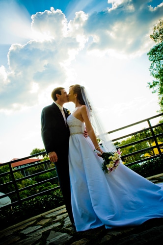 Chris Gillyard Photography - bride and groom kissing on balcony