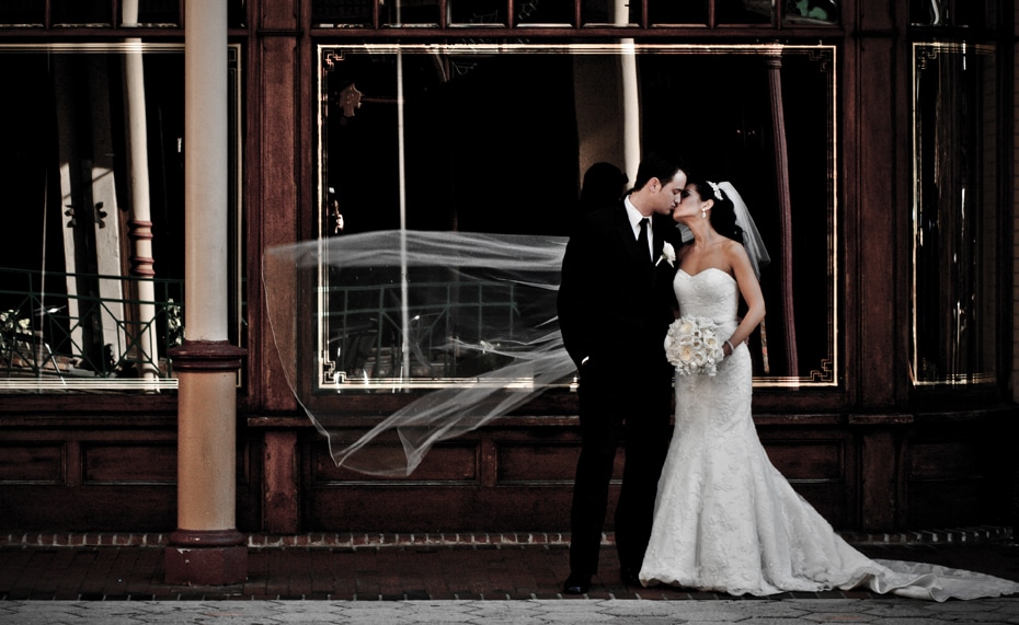 Chris Gillyard Photography - bride and groom in front of vintage storefront