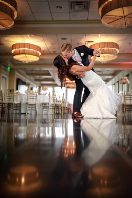 Citrus Club - groom dipping bride in reception hall