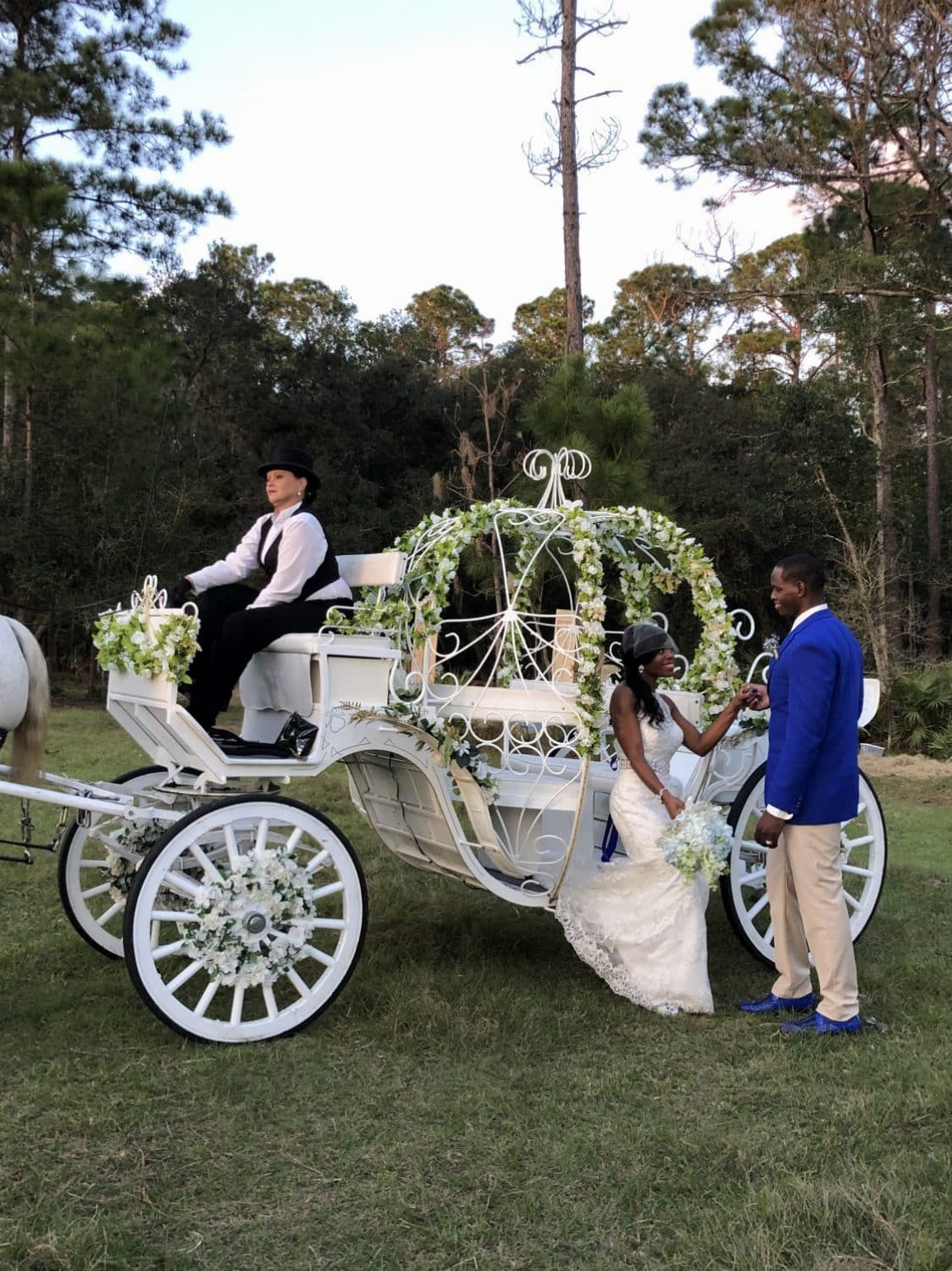 Club Lake Plantation - groom helping bride out of pumpkin coach