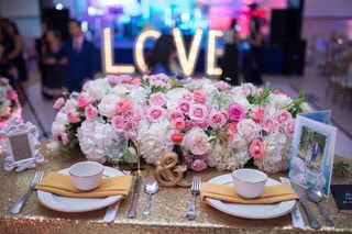 Enchanted Nights - sweetheart table covered in flowers and gold glitter tablecloth