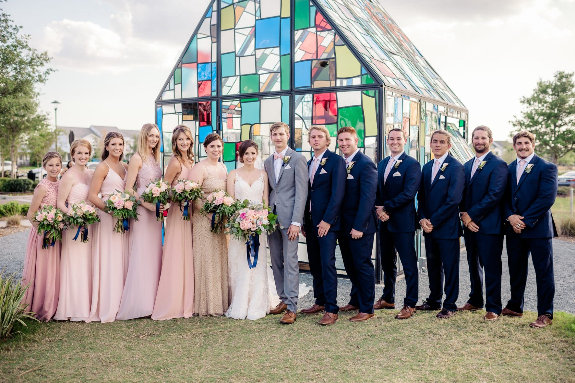 Lakehouse Lake Nona - bridal party in front of stunning stained glass chapel