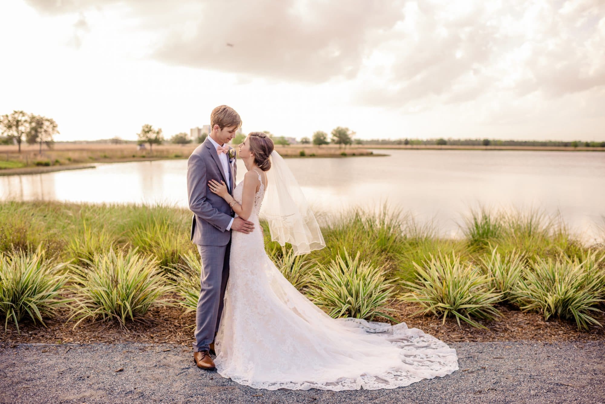 Lakehouse Lake Nona - bride and groom next to lake in Florida prairie setting