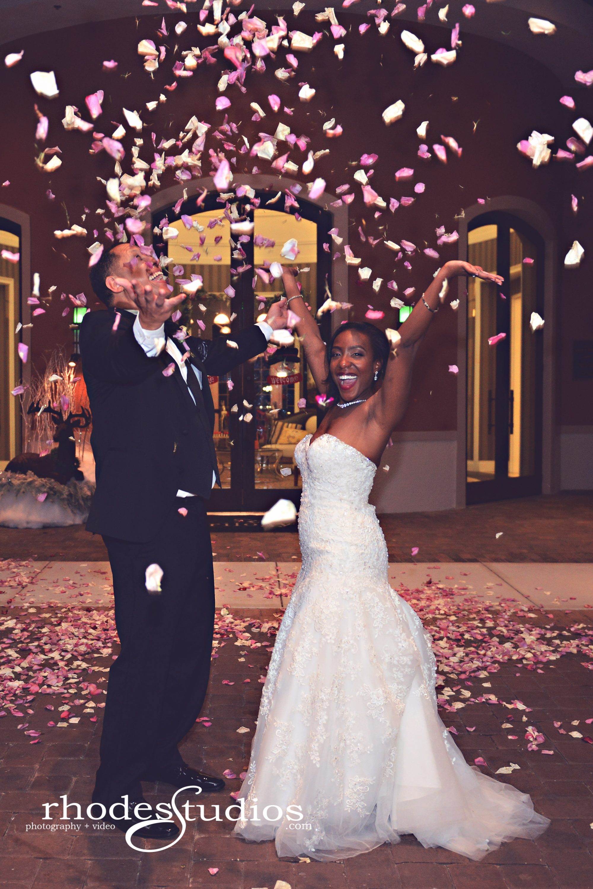 Magnolia House - bride and groom throwing flower petals like confetti