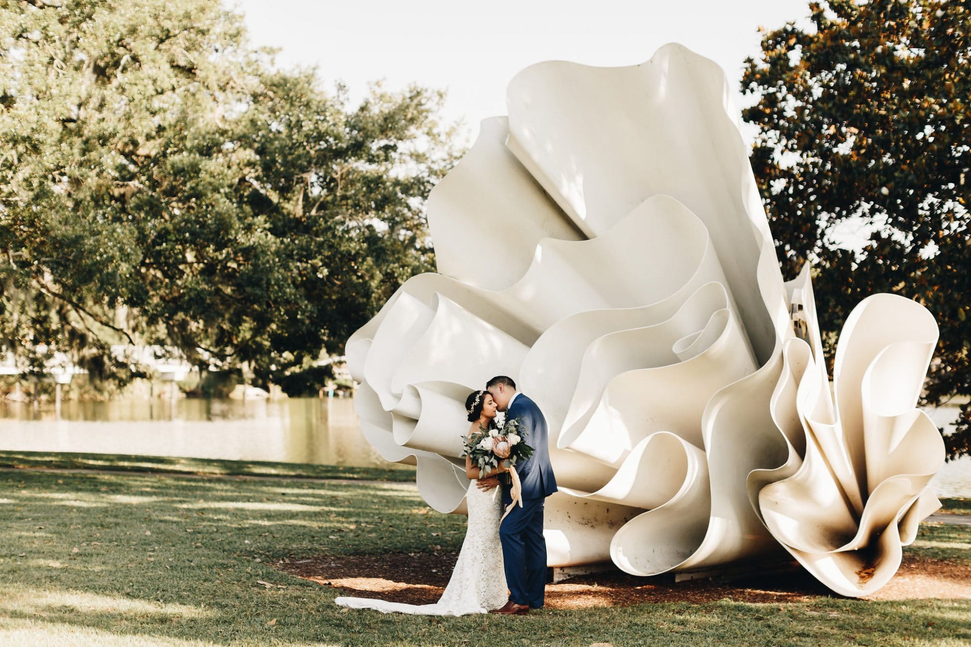 Mennello Museum of American Art - bride and groom kissing beside large outdoor sculpture
