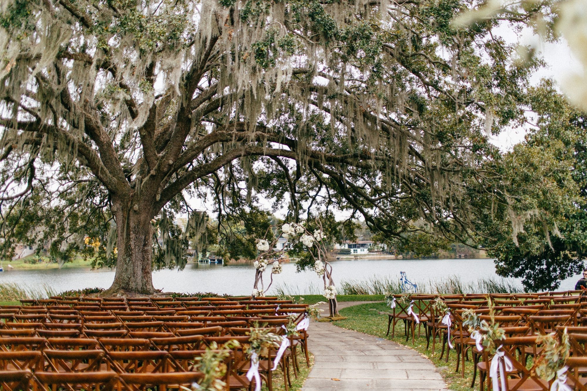Mennello Museum of American Art - waterfront ceremony with rustic chairs under large oak tree