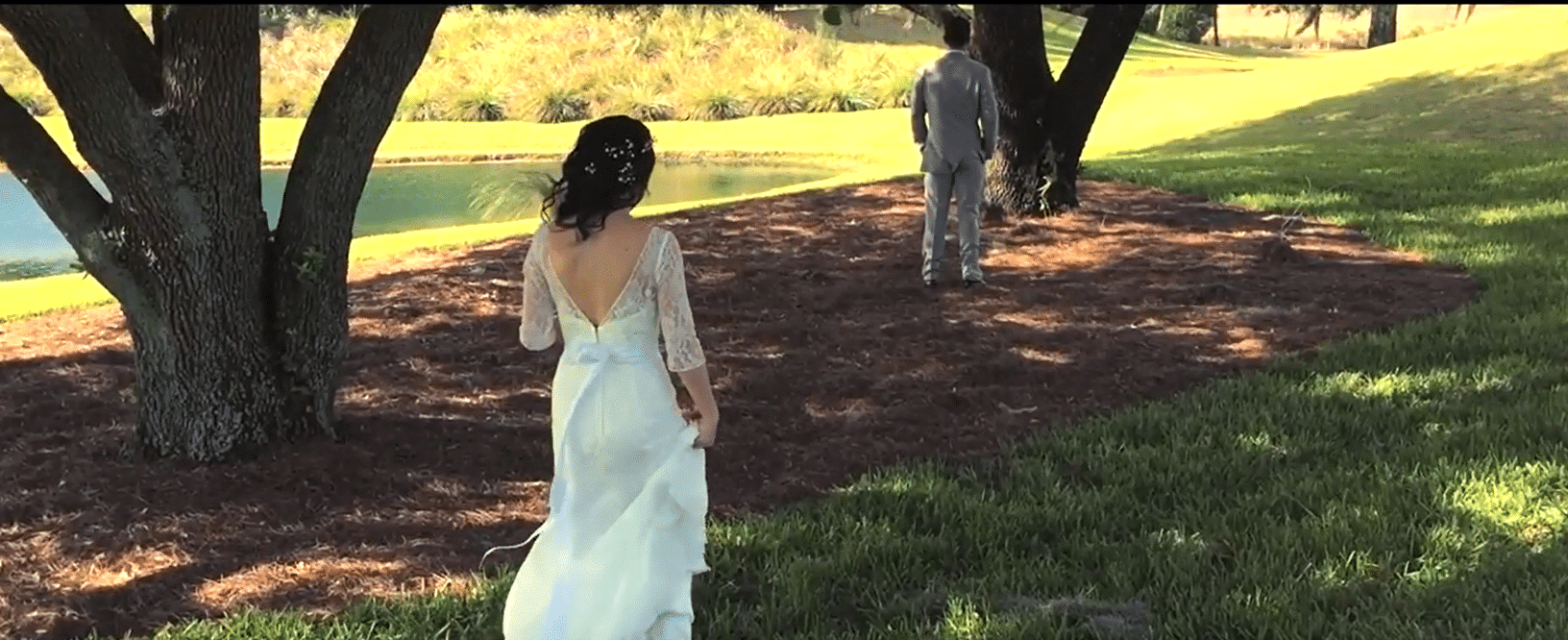 Oasis Club at ChampionsGate - bride approaching groom for first look beside lake
