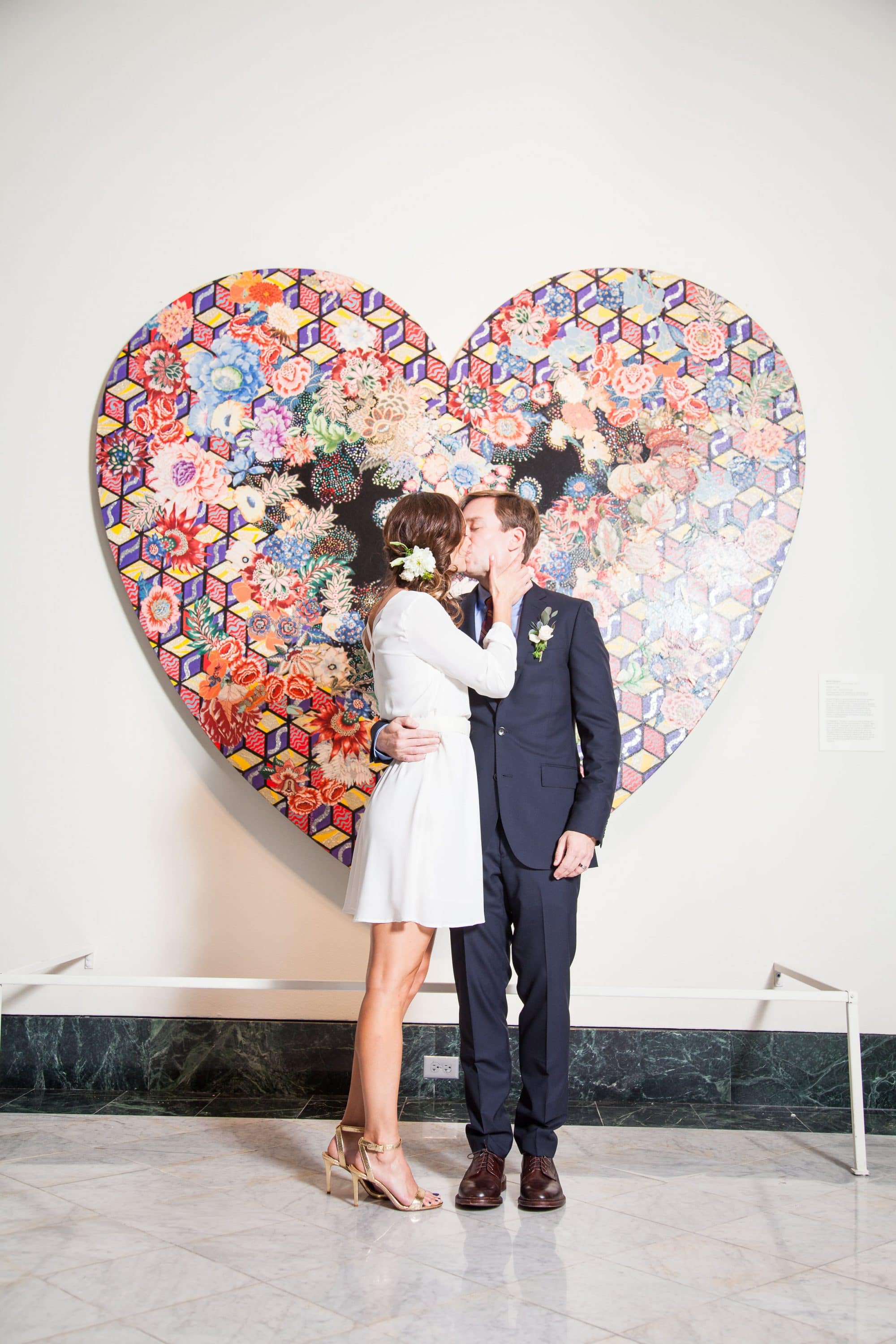 Orlando Museum of Art - bride and groom kissing in front of heart-shaped artwork