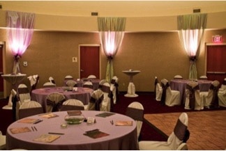 Orlando Shakes - reception tables in round room with dramatic uplighting
