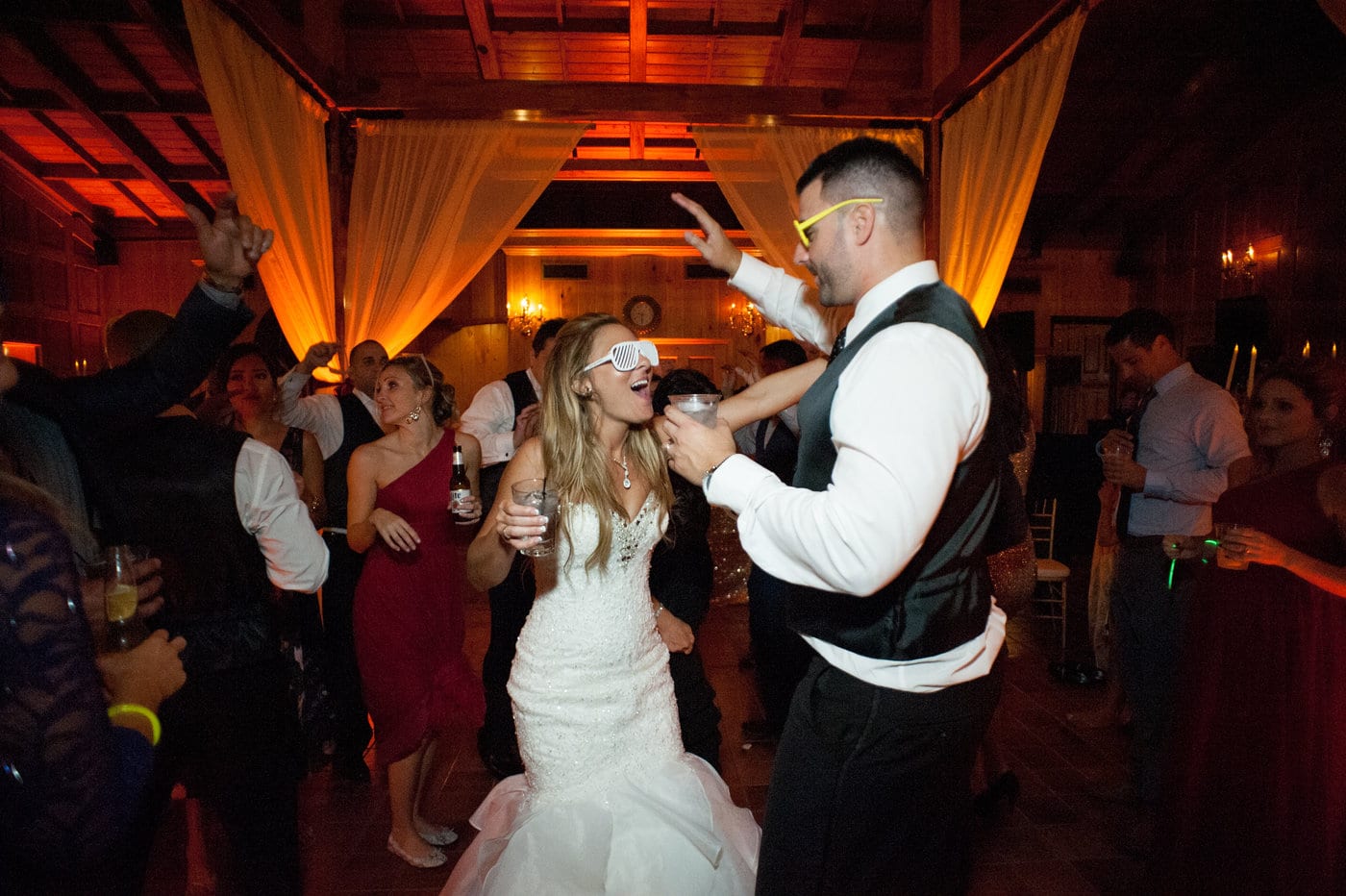 Press Play Entertainment - bride and groom with drinks and sunglasses on dance floor