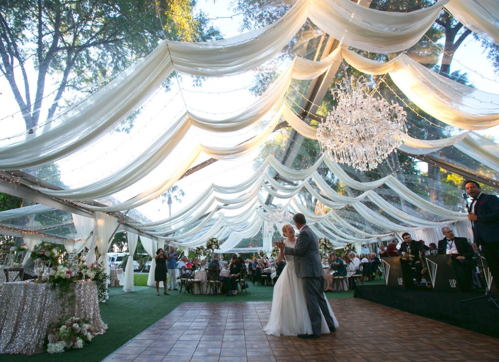 Rentaland Tents and Events - Bride and groom dancing under canopy of white drapery