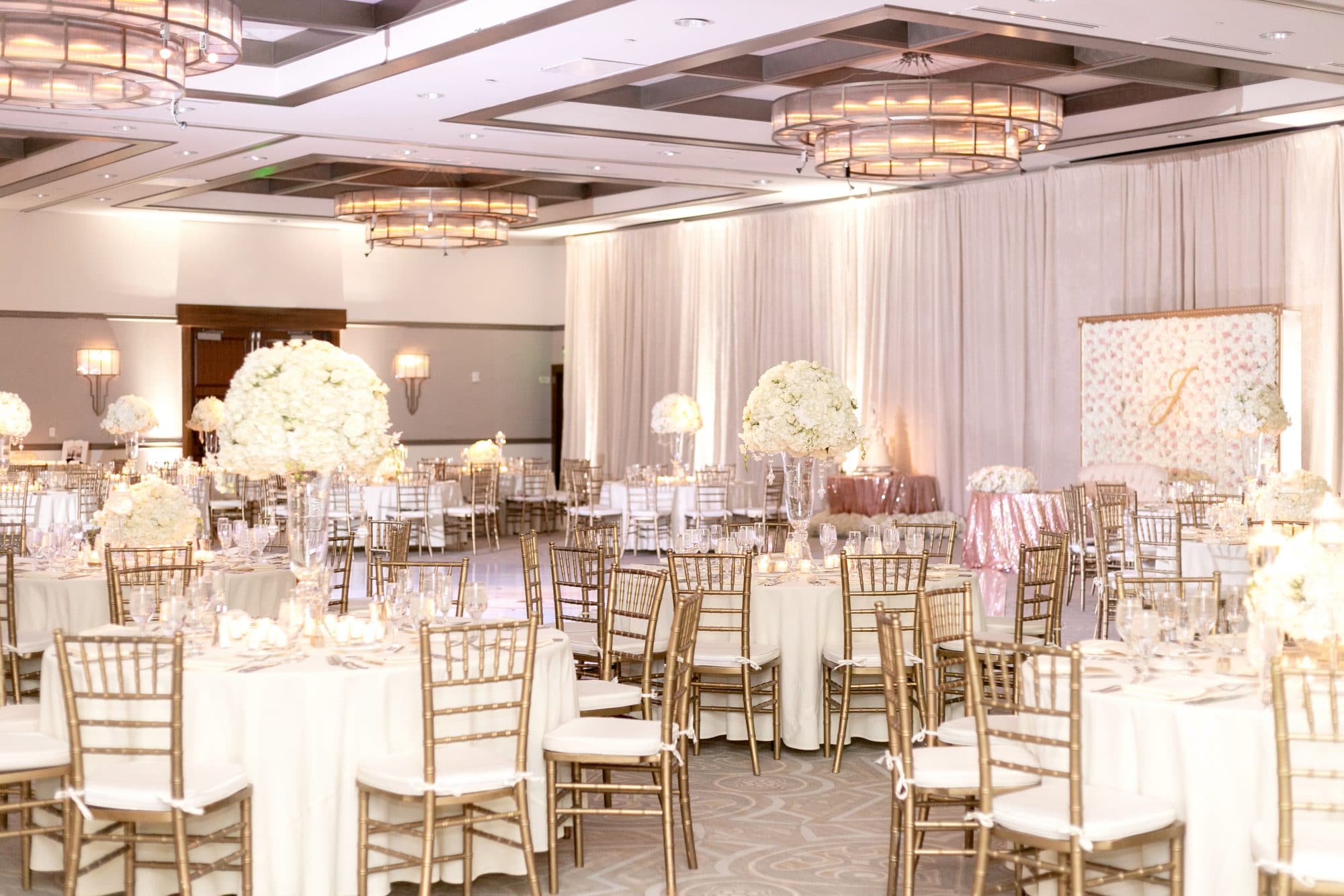Alfond Inn - glamorous reception space with white fabric-draped walls and modern chandeliers