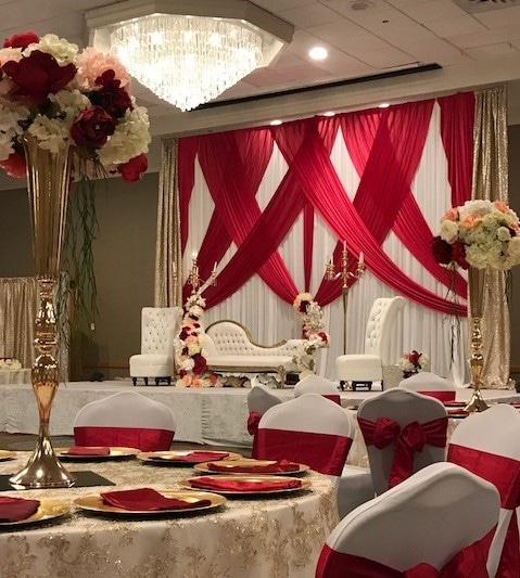 Florida Hotel and Convention Center - upholstered seating on stage with gorgeous white and red drapery backdrop