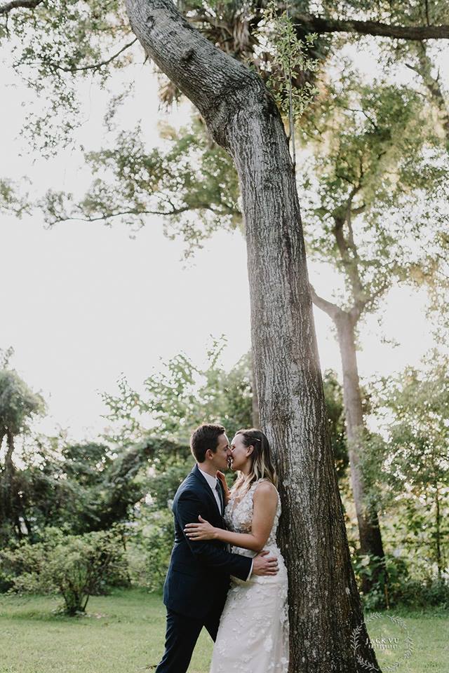 The Garden Villa - bride and groom kissing near tall trees