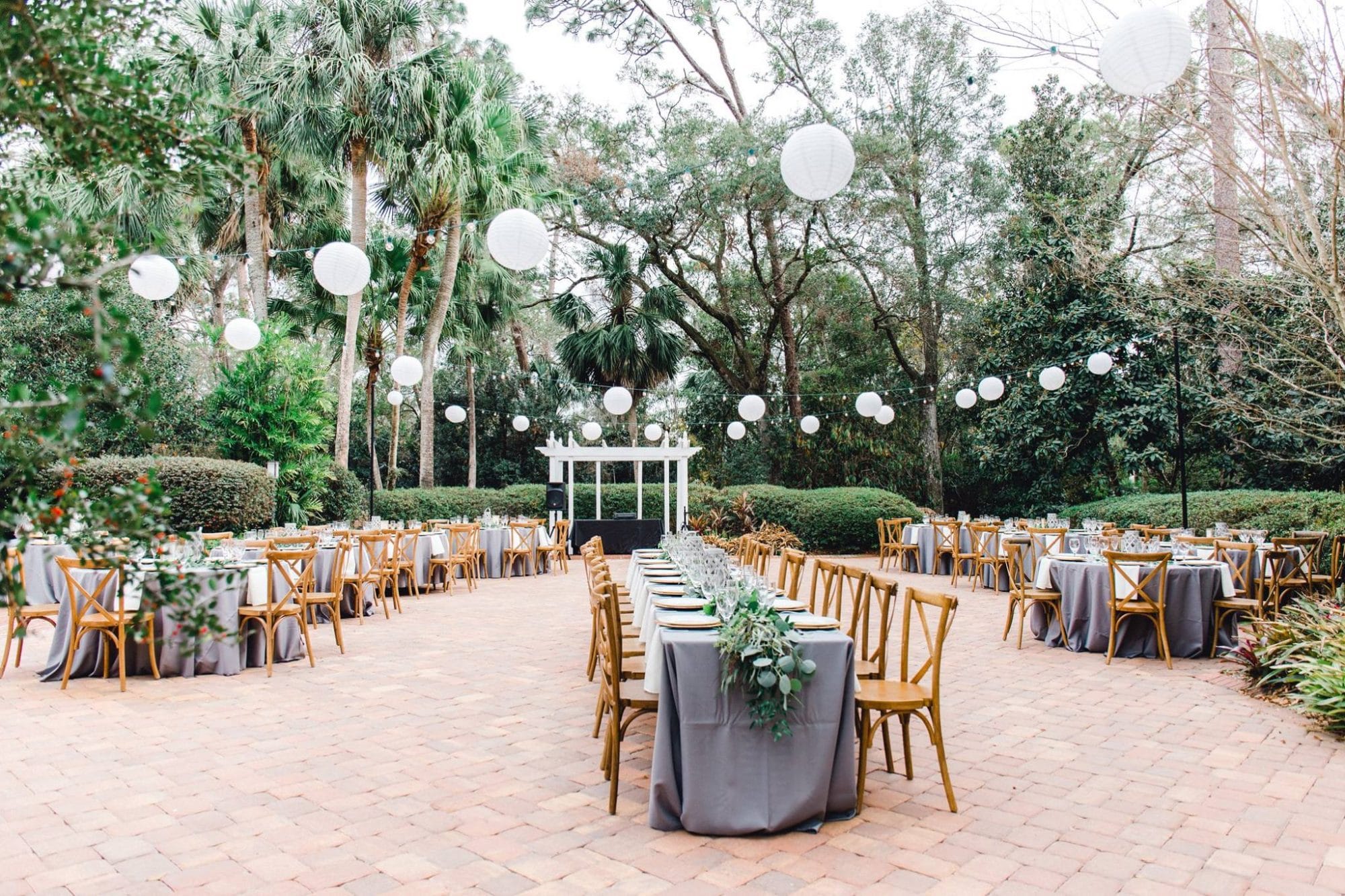 The Garden Villa - large outdoor brick patio strung with lantern globe lights