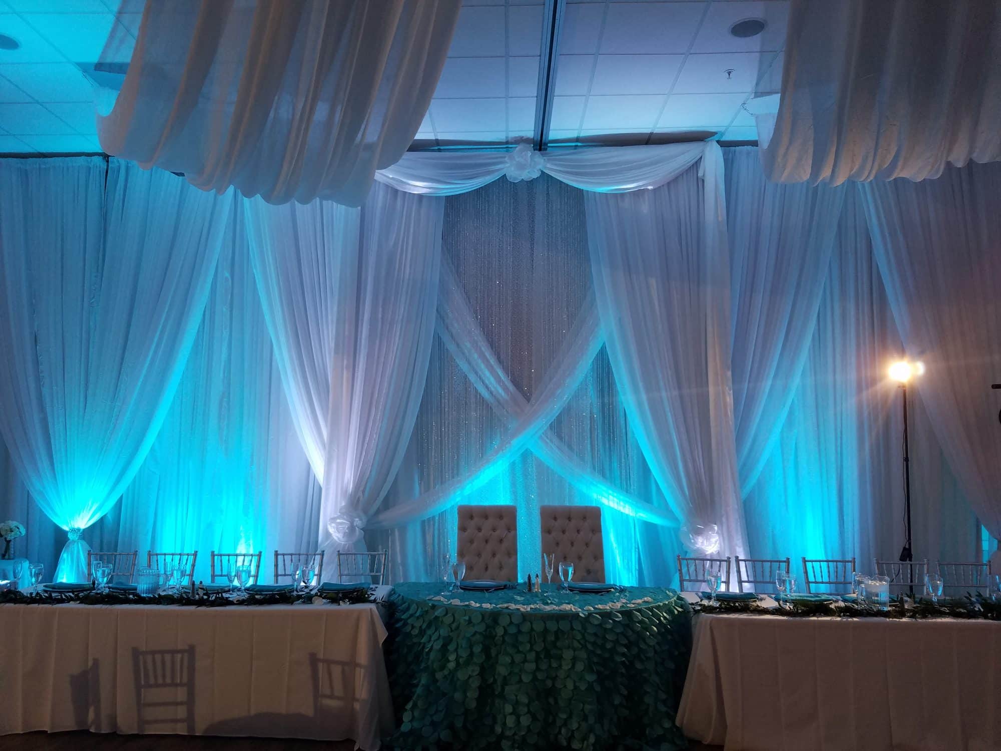 The Grand Manor - white fabric draping behind sweetheart table