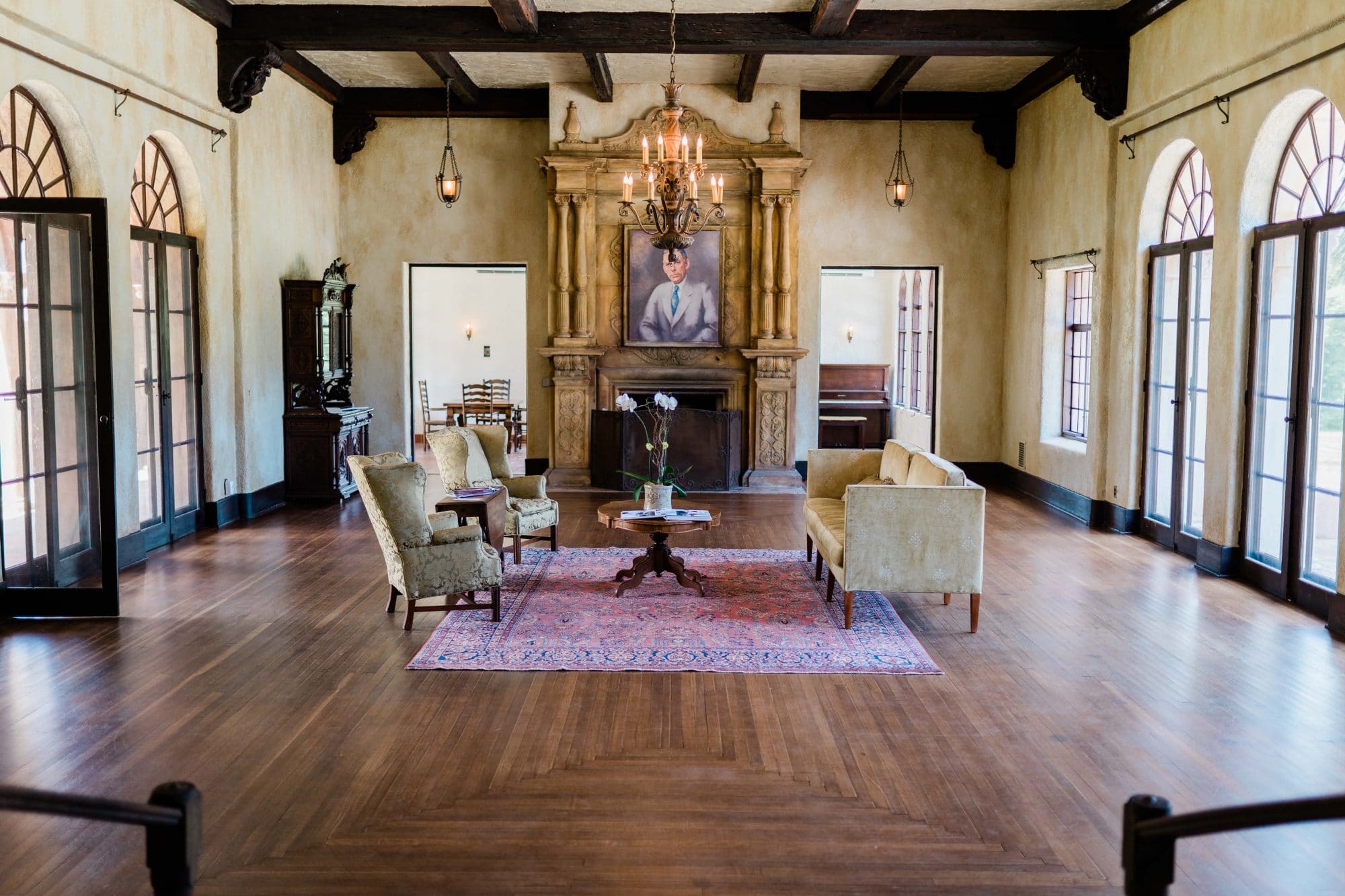 The Howey Mansion - large indoor sitting room with huge windows and fireplace