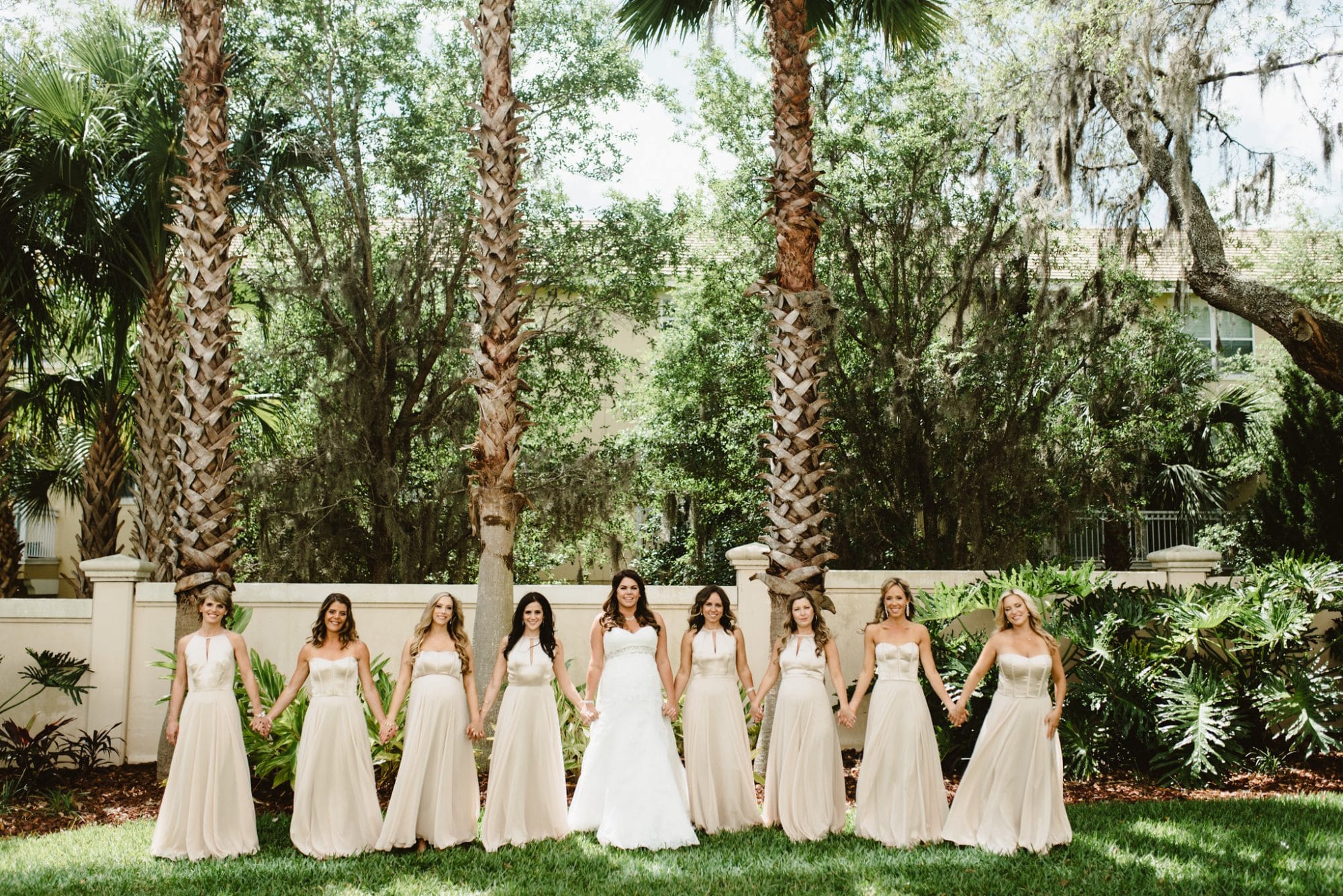Westin Lake Mary - bridal party holding hands in garden location