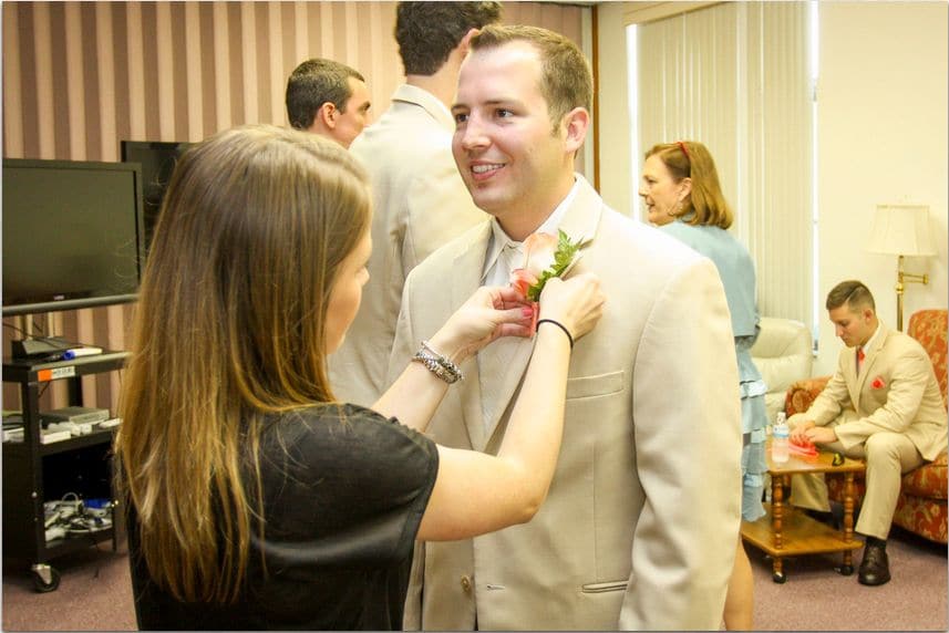 Plan It Events - Caitlin pinning boutonniere on a groom