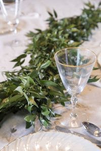 The Magnolia Company - loose, low greenery makes a beautiful, yet unintrusive centerpiece