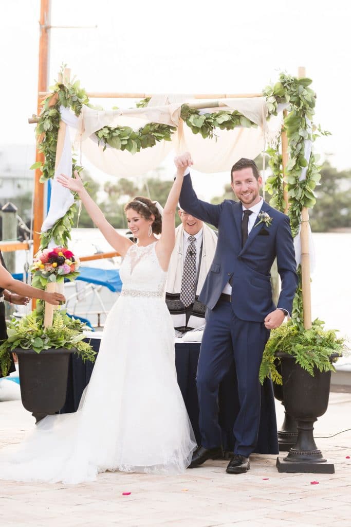 Rabbi Olshansky - bride and groom holding hands up