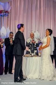 Rabbi Olshansky - rabbi laughs with bride and groom during ceremony