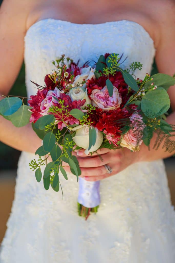 With This Ring - bride holding bouquet of flowers