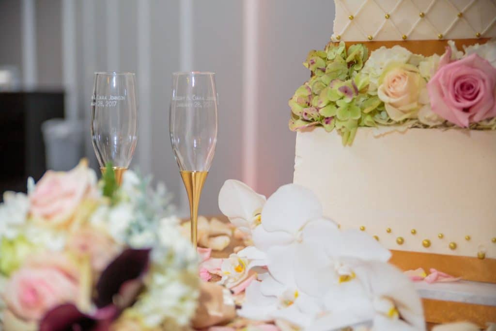 With This Ring - personalized champagne flutes next to wedding cake