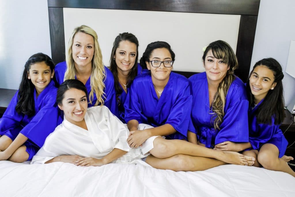 With This Ring - bridal party lounging on bed in robes