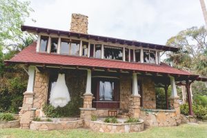 Estate on the Halifax - Wedding dress handing ourdoors on porch of stone cottage on property