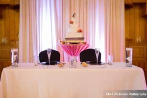 Estate on the Halifax - Bride and Groom table setting with four tier cake in background