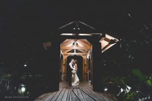 Estate on the Halifax - Intimate moment with Bride and Groom outdoors at night on bridge with train tracks and water