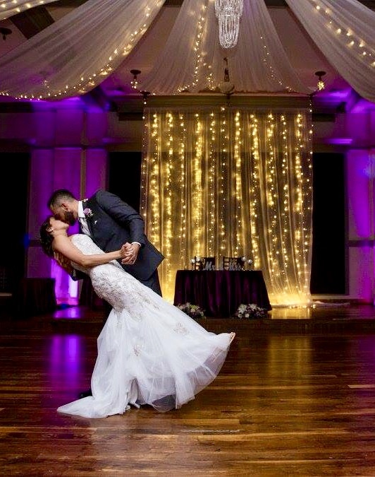 bride and groom share their first dance with gold and purple accents after ceremony performed by Hearts & Souls Officiant an Orlando Wedding Officiant