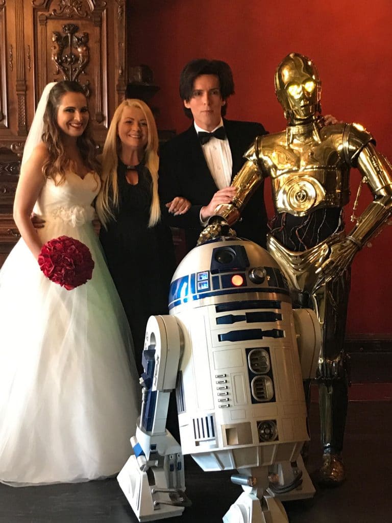 Star Wars themed wedding with C3PO and R2D2, bride and groom and Hearts & Souls Officiant an Orlando Wedding Officiant