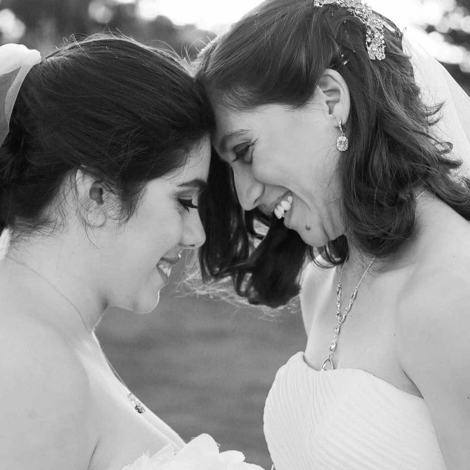 black and white photo of brides smiling after ceremony performed by Hearts & Souls Officiant an Orlando Wedding Officiant