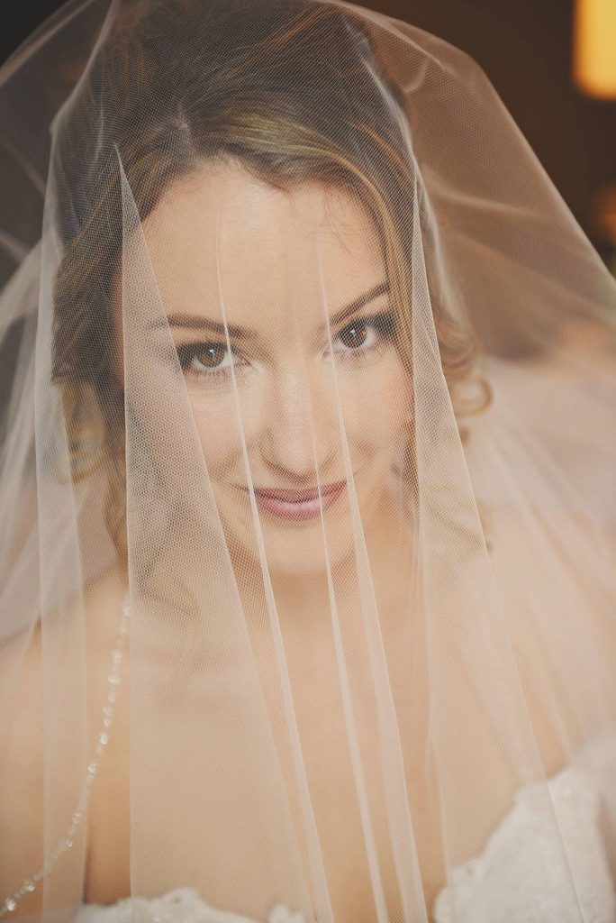 bride smiling through veil