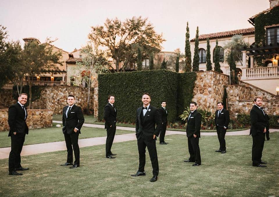 That First Moment - groom and groomsmen scattered on lawn at Bella Collina