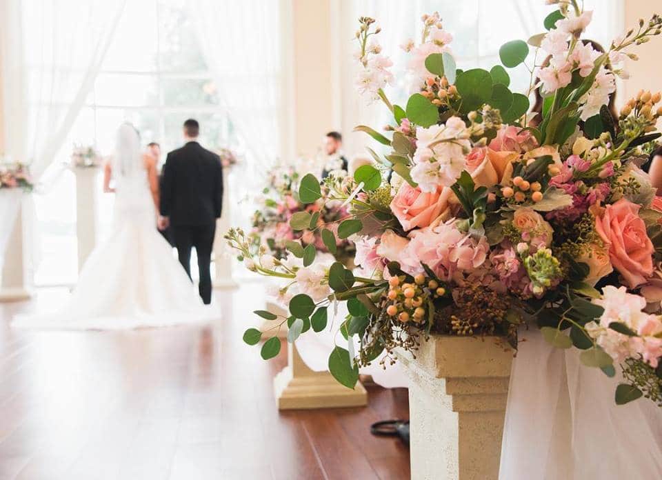 That First Moment - ceremony aisle flower arrangement with eucalyptus and roses