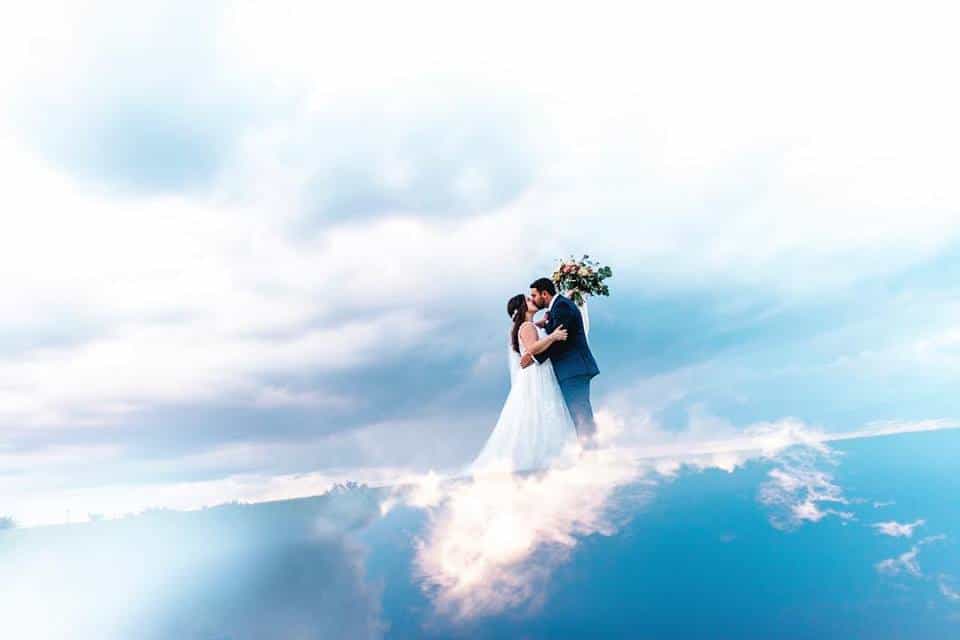 That First Moment - bride and groom kissing on a cloud