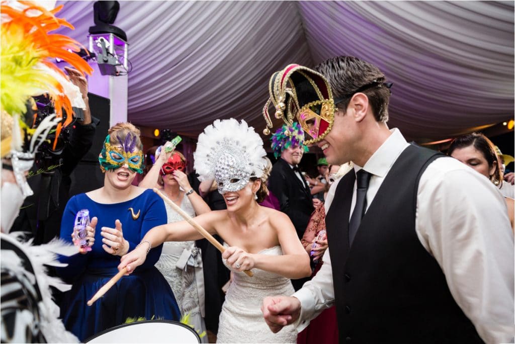 iRock Your Party - bride plays drums with party in masquerade masks