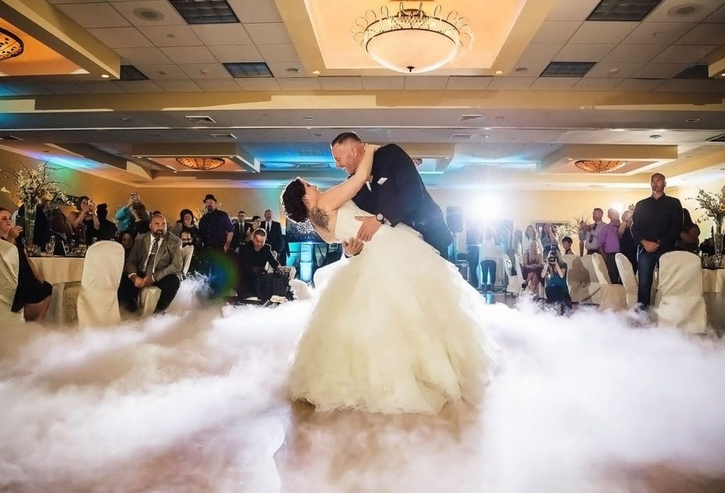 iRock Your Party has groom dipping bride on dance floor surrounded with mist