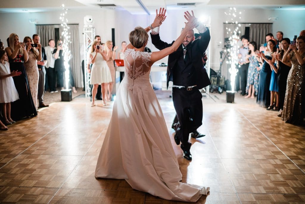 bride and groom dancing with indoor firewords