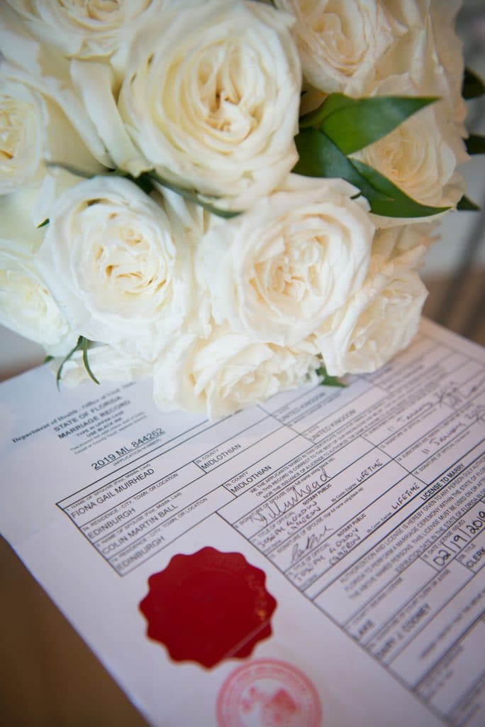 Florida Marriage license with red stamp and white roses