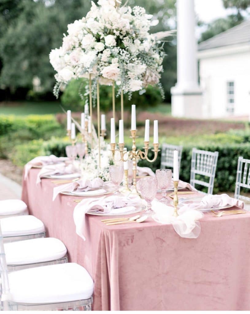 Wedding table set with pink linens and tall table center piece